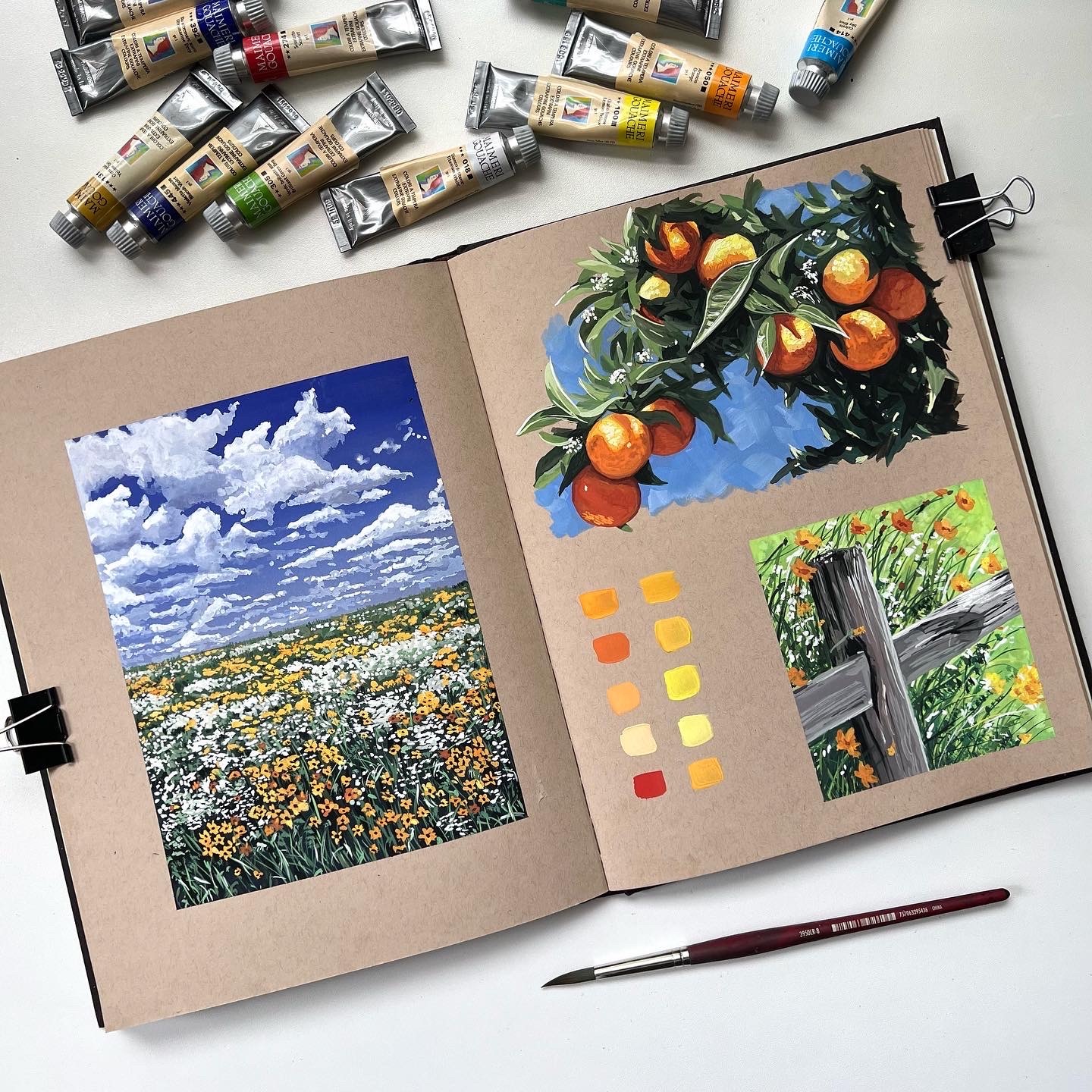 Art journal pages featuring landscapes, oranges, and color swatches.