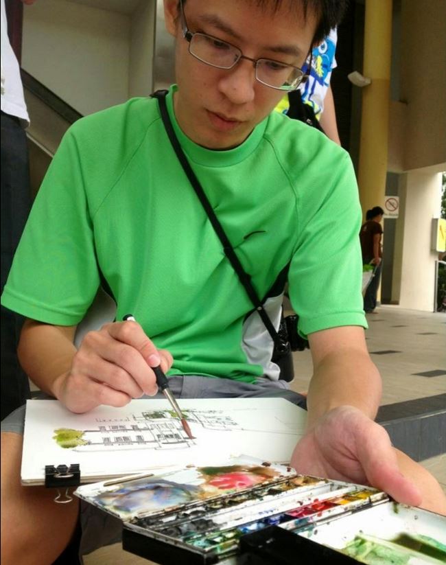 "Artist painting outdoors with watercolors on sketchpad."